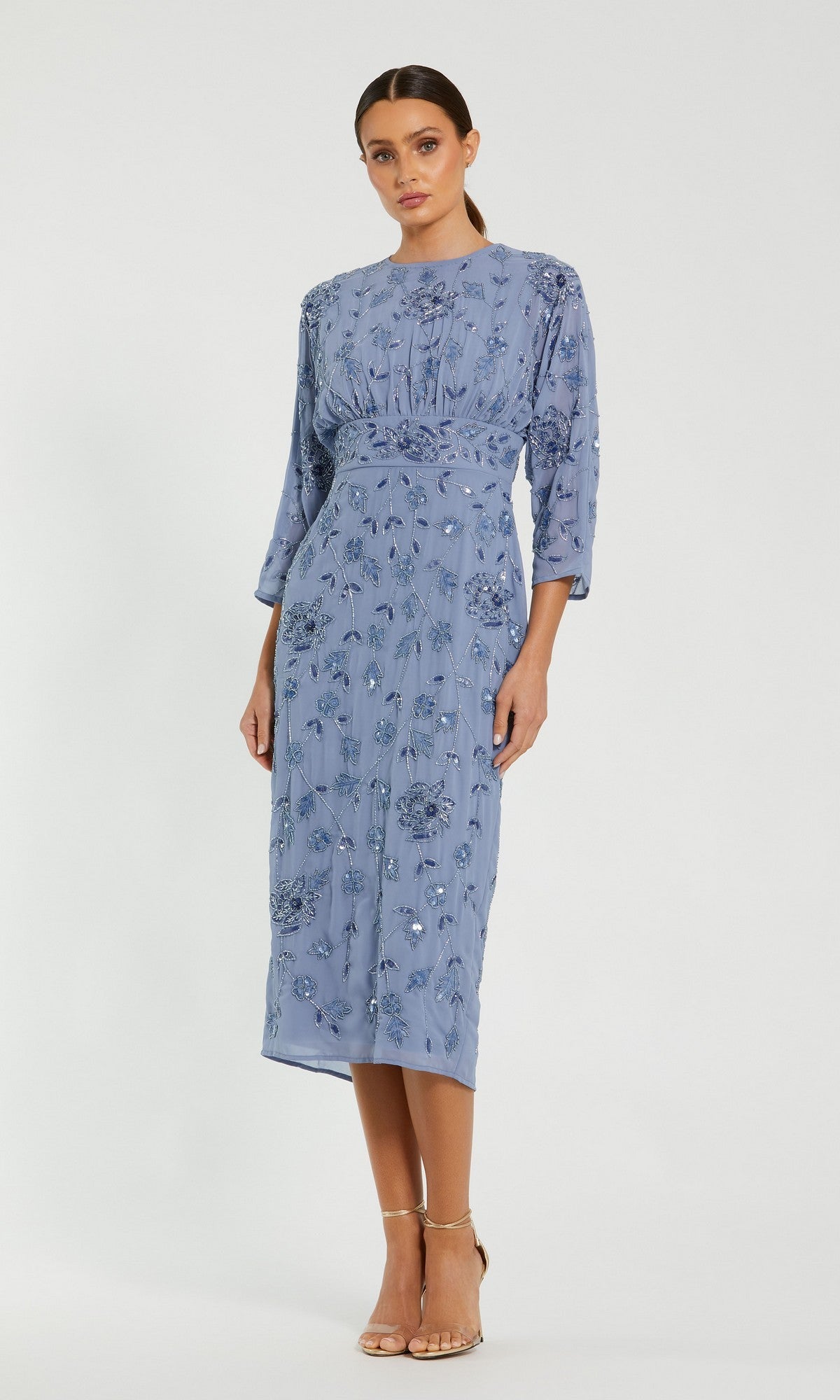 A woman stands in a neutral pose against a plain background, wearing the Mac Duggal 94141 Midi Party Dress in twilight—an elegant modest cocktail dress with delicate embroidery and three-quarter sleeves—paired with nude strappy heels, perfect for any occasion.